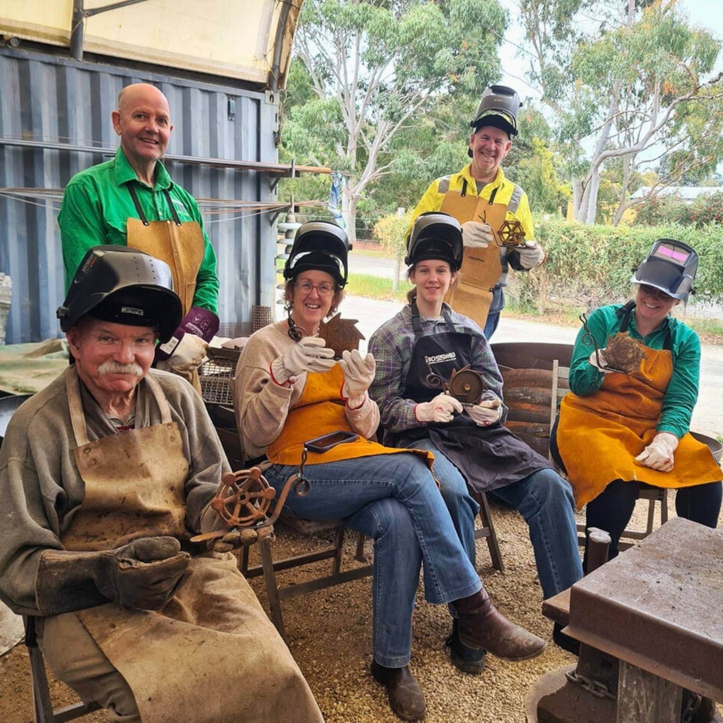 Happy class mates with their own snail metal artworks they made at the Designer Dirt workshop, with their teacher Ian 