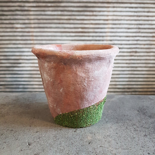 Small rustic terracotta pots with artificial moss